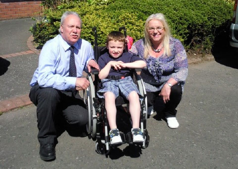 Gerry and Geraldine presenting JAmie with his new wheelchair